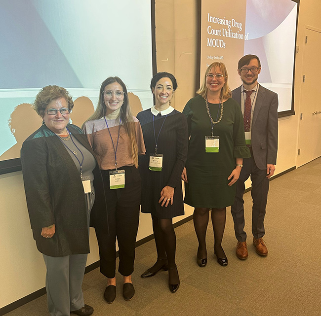 group of presenters posing at event